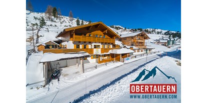 Hotels an der Piste - Sonnenterrasse - Ski Obertauern - Ferienwohnungen Petergstamm in Obertauern, mitten im Winter, Pisten fußläufig in 1 Minute erreichbar. Genießen Sie den Traum der Tauernrunde. - Appartementhaus Petergstamm