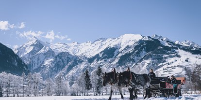 Hotels an der Piste - Ladestation Elektroauto - Kaprun - Pferdeschlittenfahrt durch die verschheite Alpenlandschaft - Hotel Sonnblick