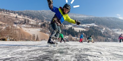 Hotels an der Piste - Treffen (Treffen am Ossiacher See) - Eislaufen am Brennsee - Trattlers Hof-Chalets